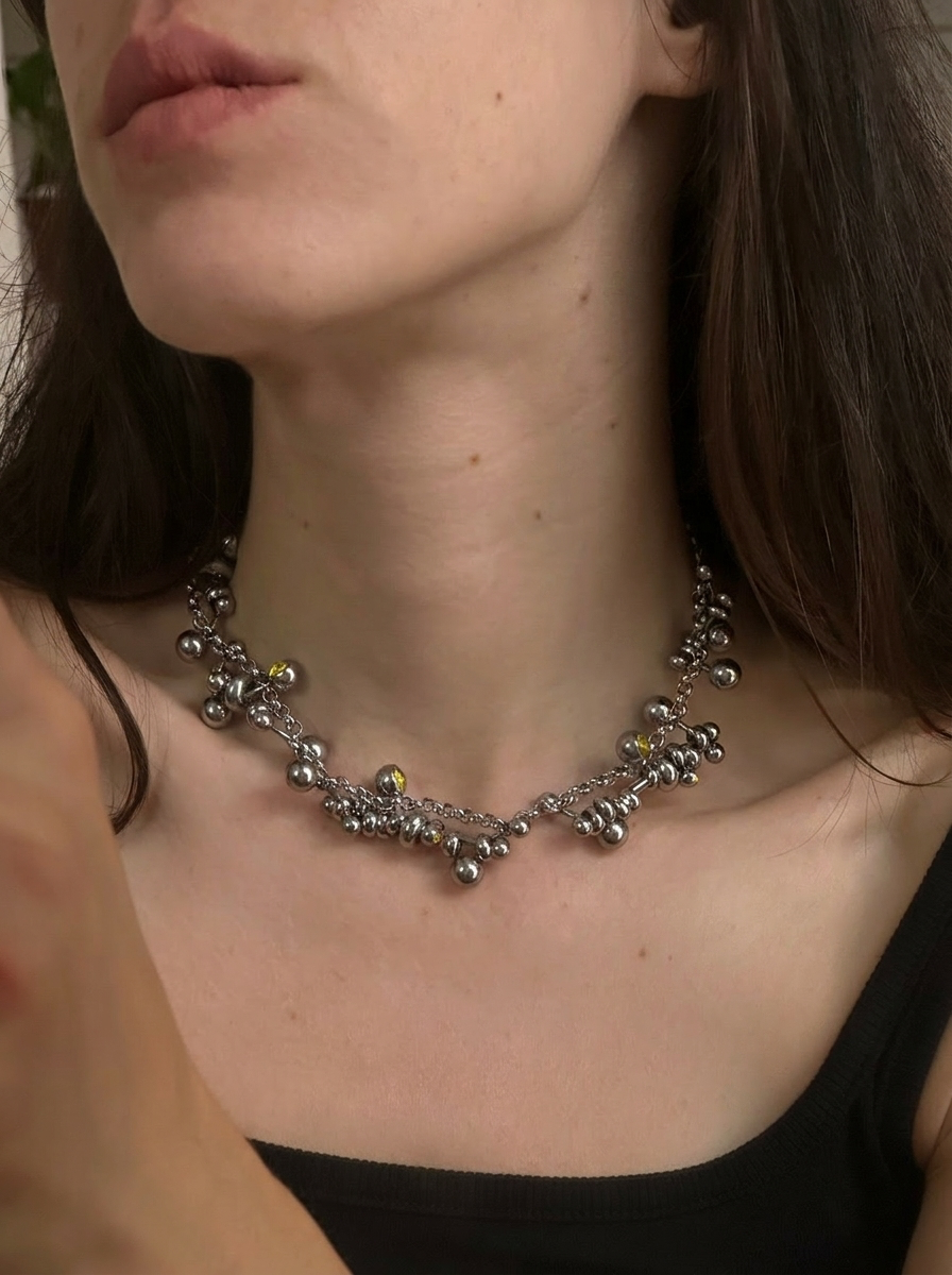 Close-up of a necklace worn by a person with a blurred background