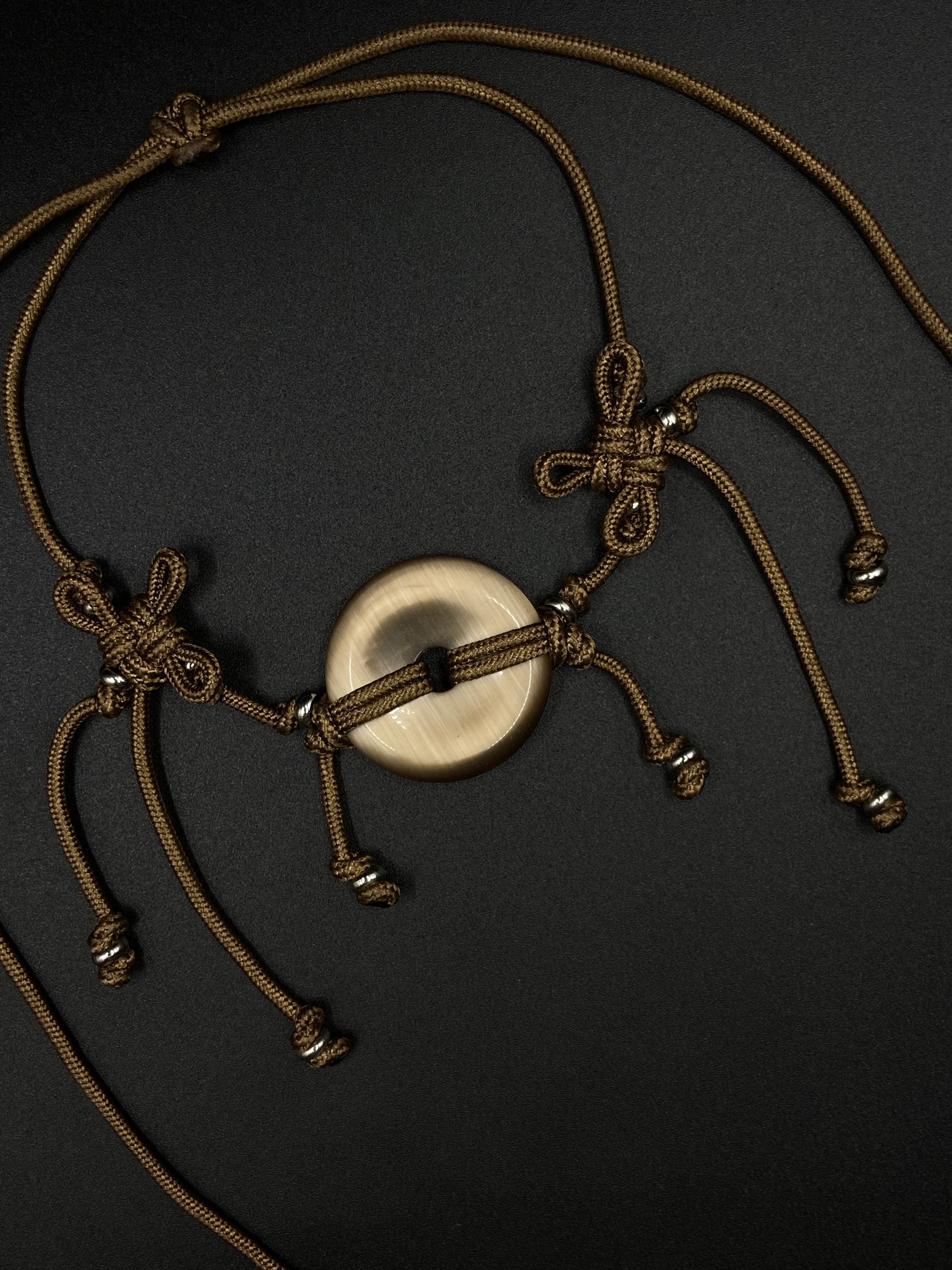 Necklace with a circular pendant on a dark background