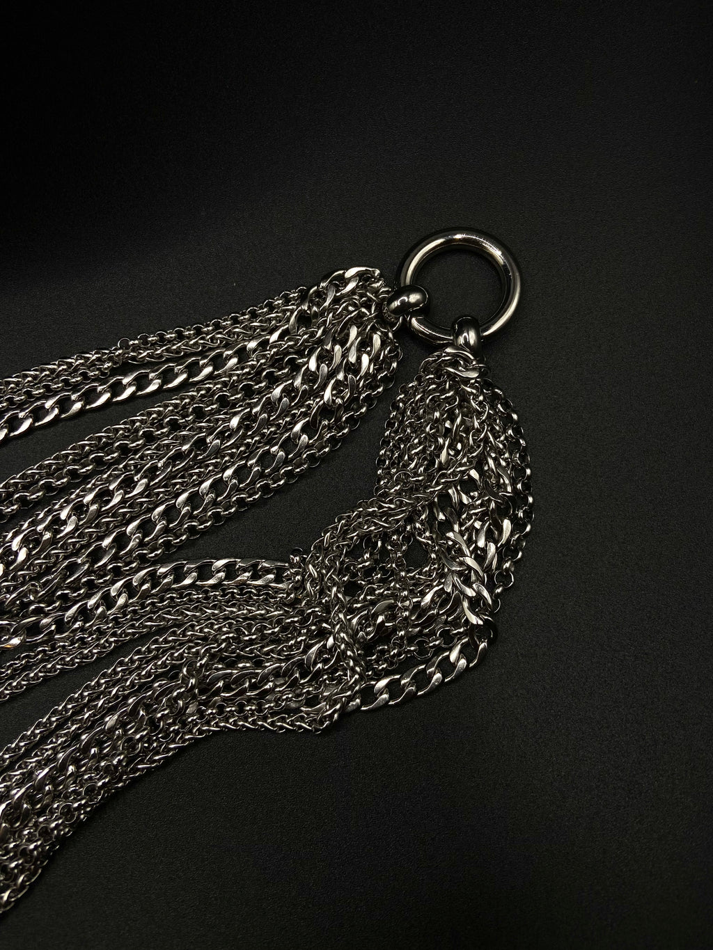 Silver chain necklace on a black background