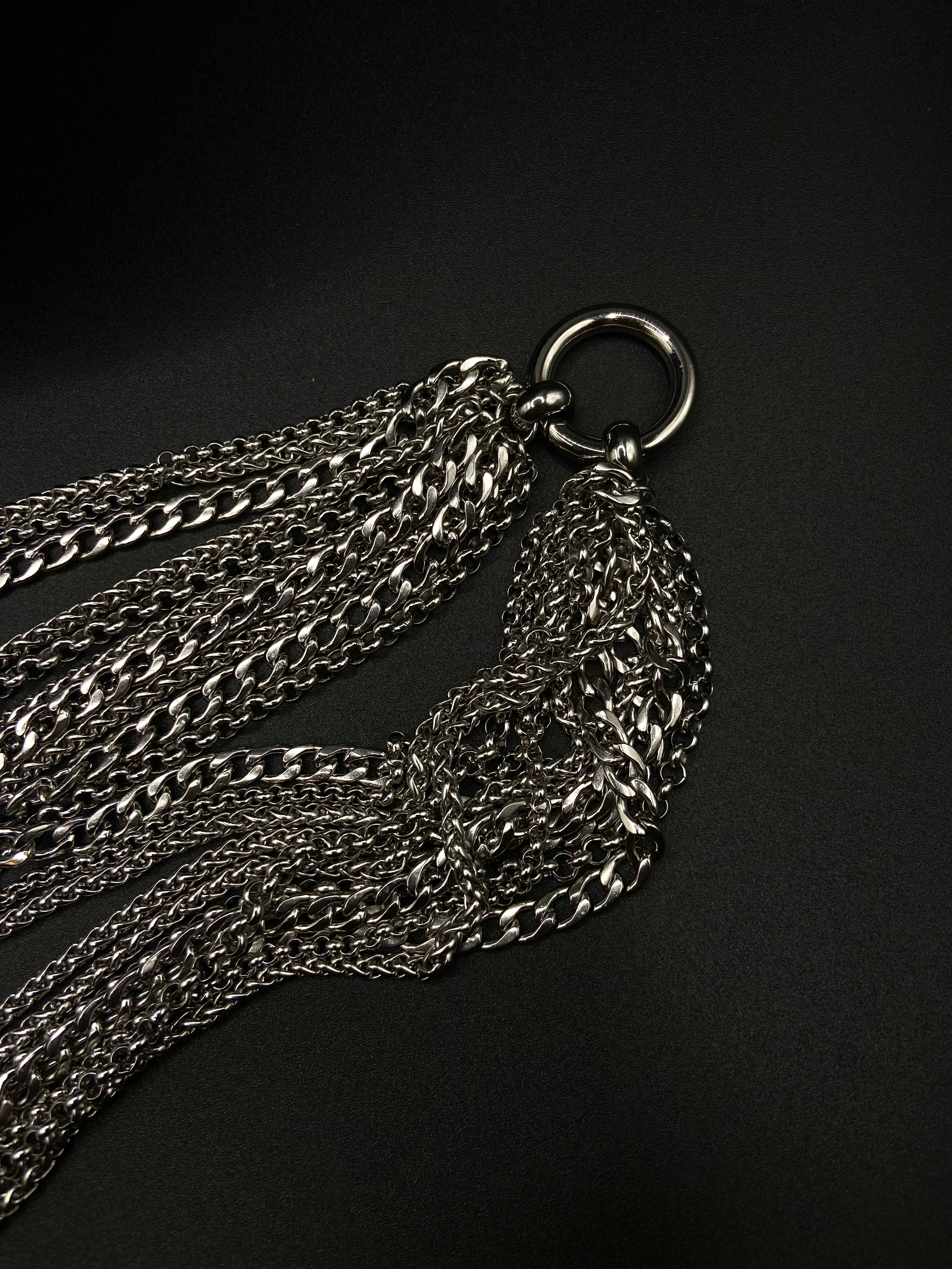 Silver chain necklace on a black background