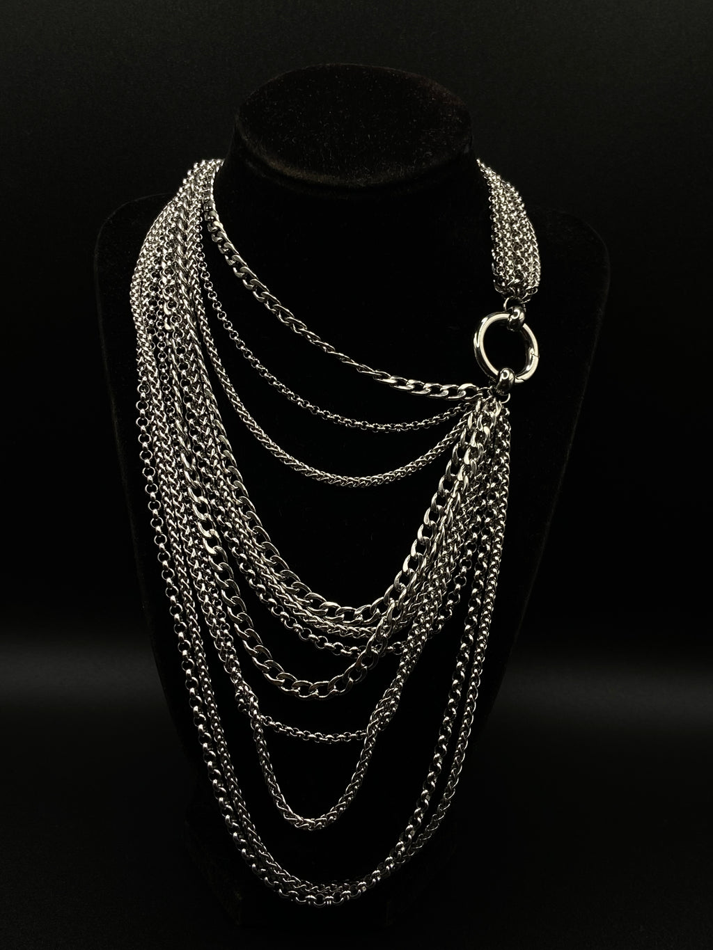 Silver chain necklace on a black background