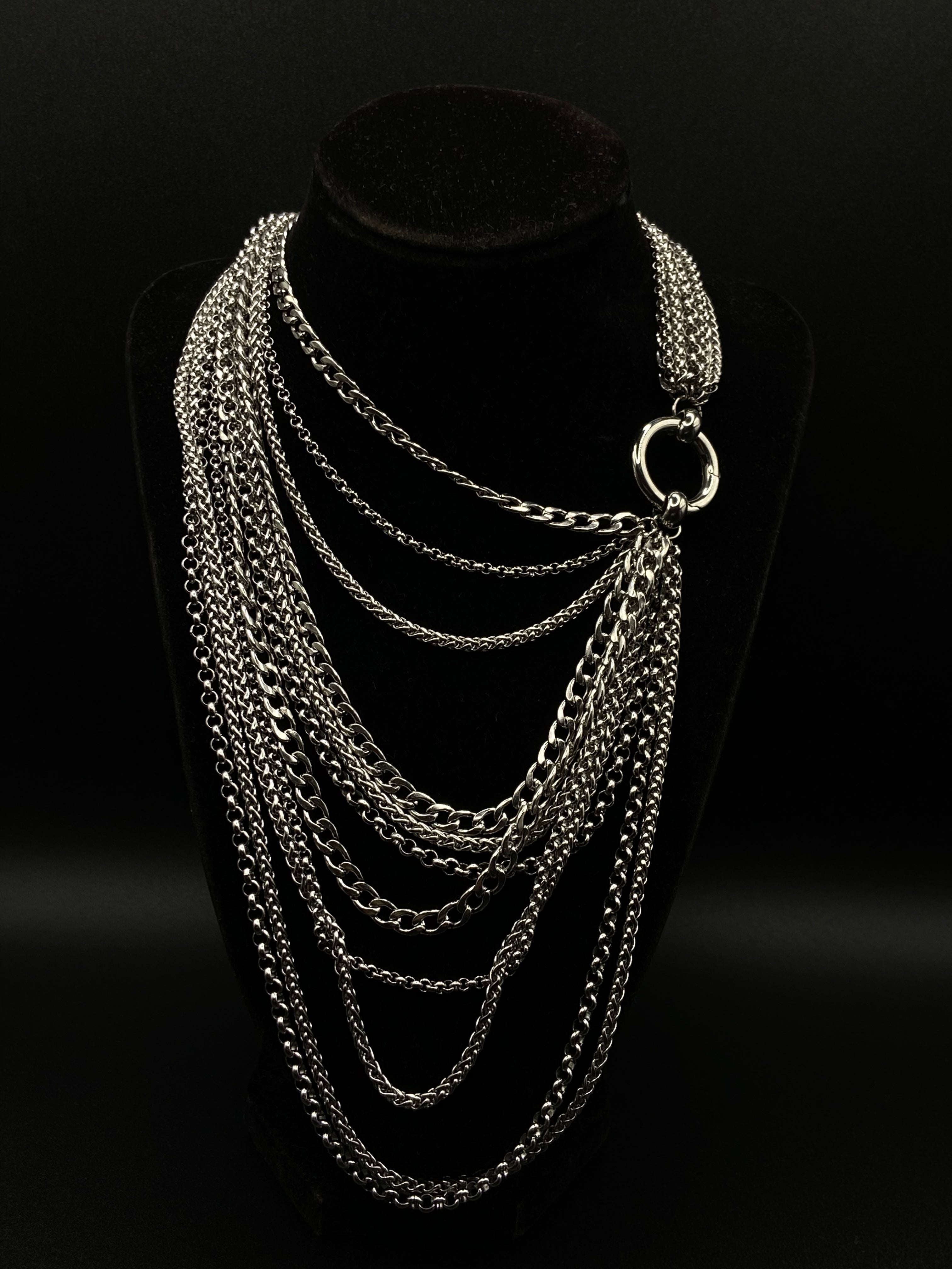 Silver chain necklace on a black background