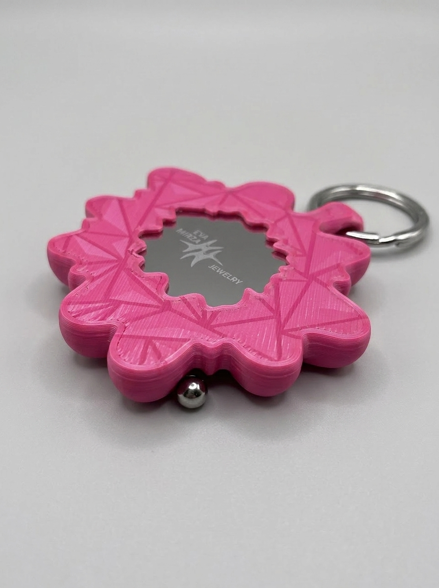 Pink keychain with a silver ring on a white background
