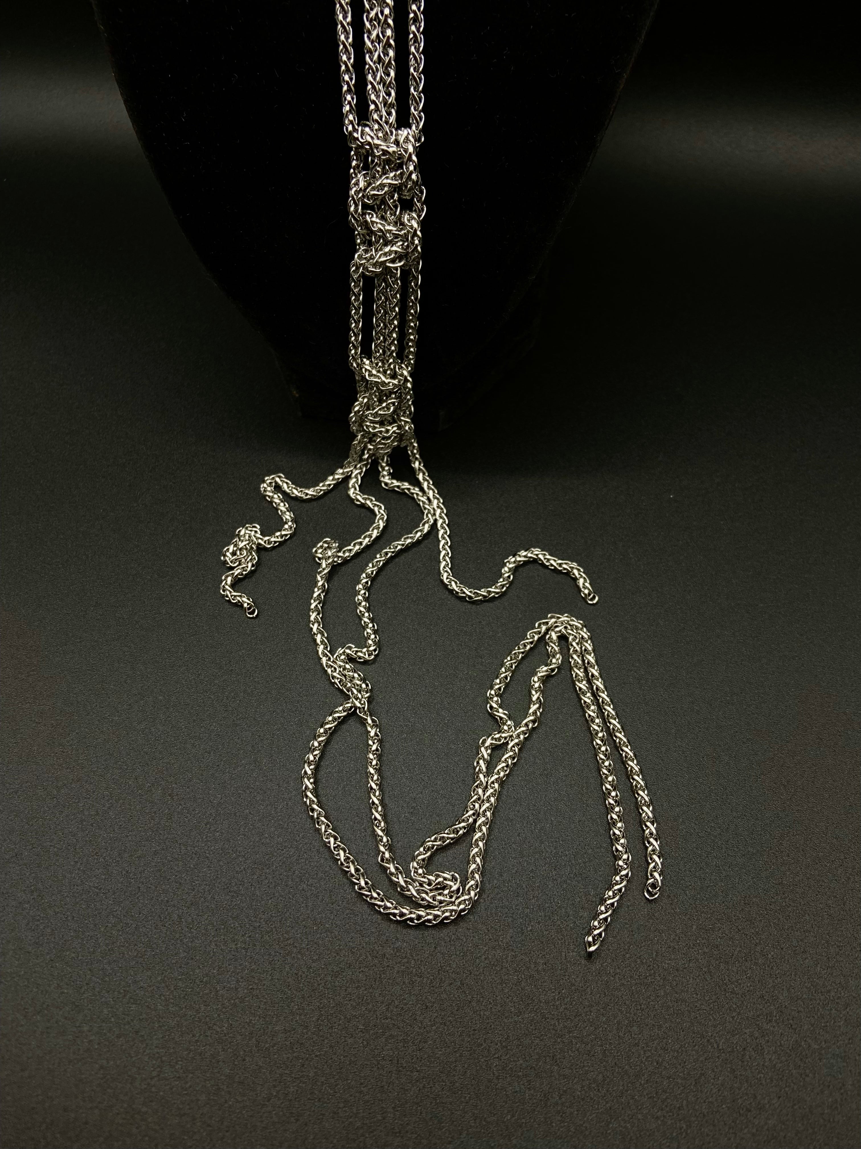 Silver chain necklace on a black background