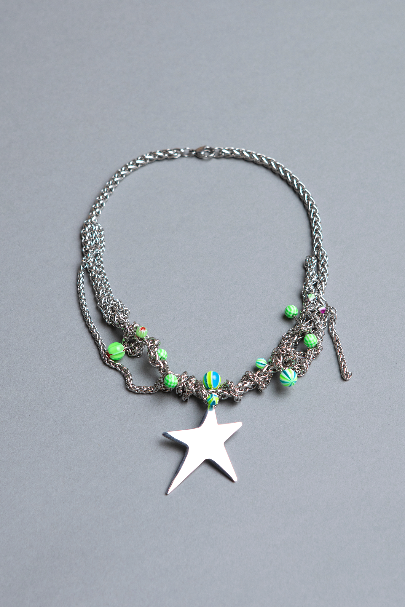 unique one of a kind stylish stainless steel green piercing star necklace